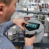 How does the LeakCam 600 thermal camera help detect compressed air leaks faster?